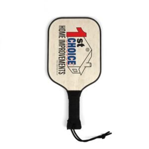 Wooden shield-shaped sign with black border, partial text 'HOME IMPROVEMENTS' and a red graphic, hung by a black rope.